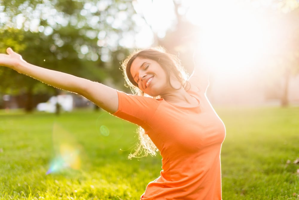 Active woman doing yoga poses at sunset